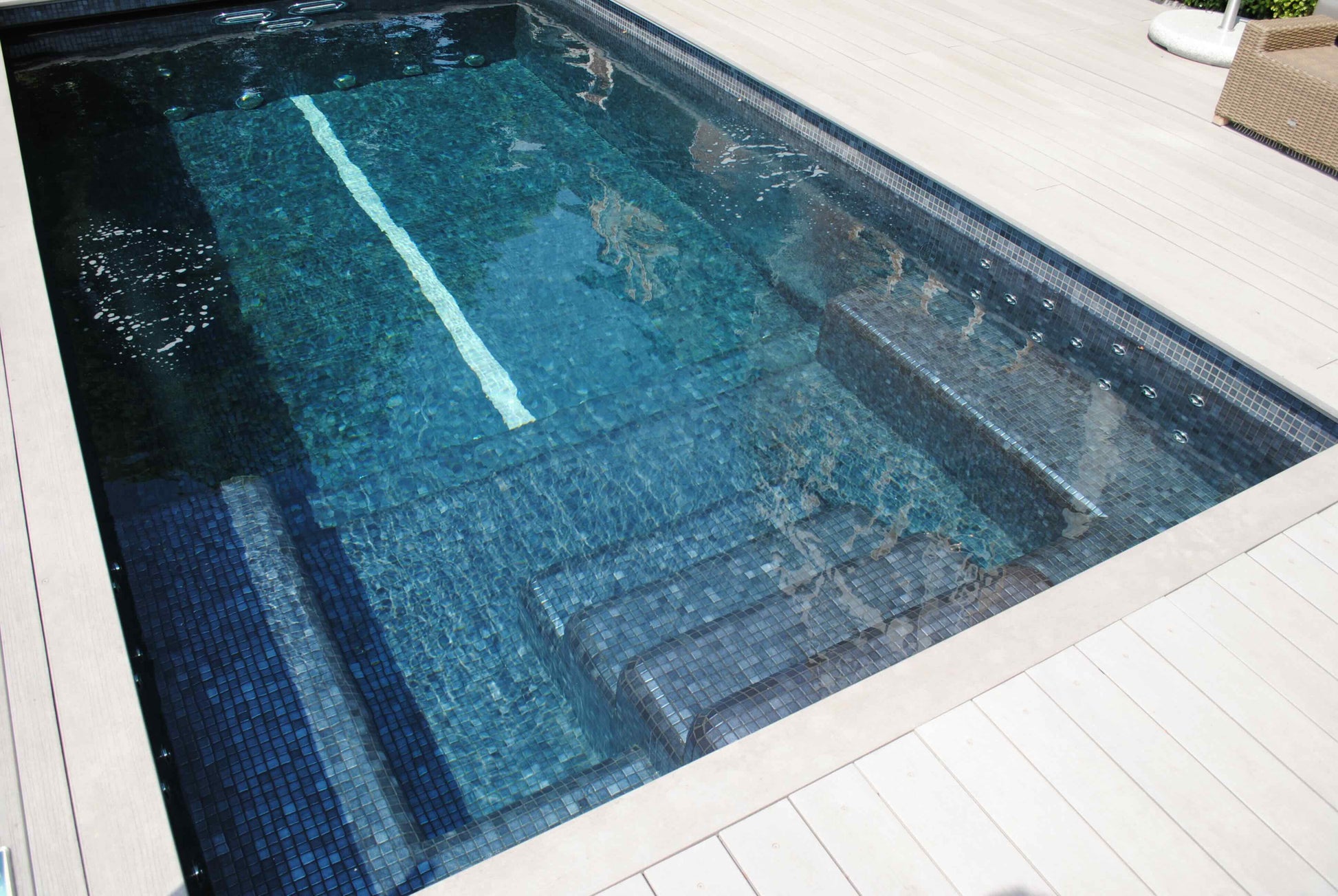 Outdoor image of Spa Living Mosaic Infinity Swim Spa Pool for 6 people, showcasing its sleek design and spacious swim area.