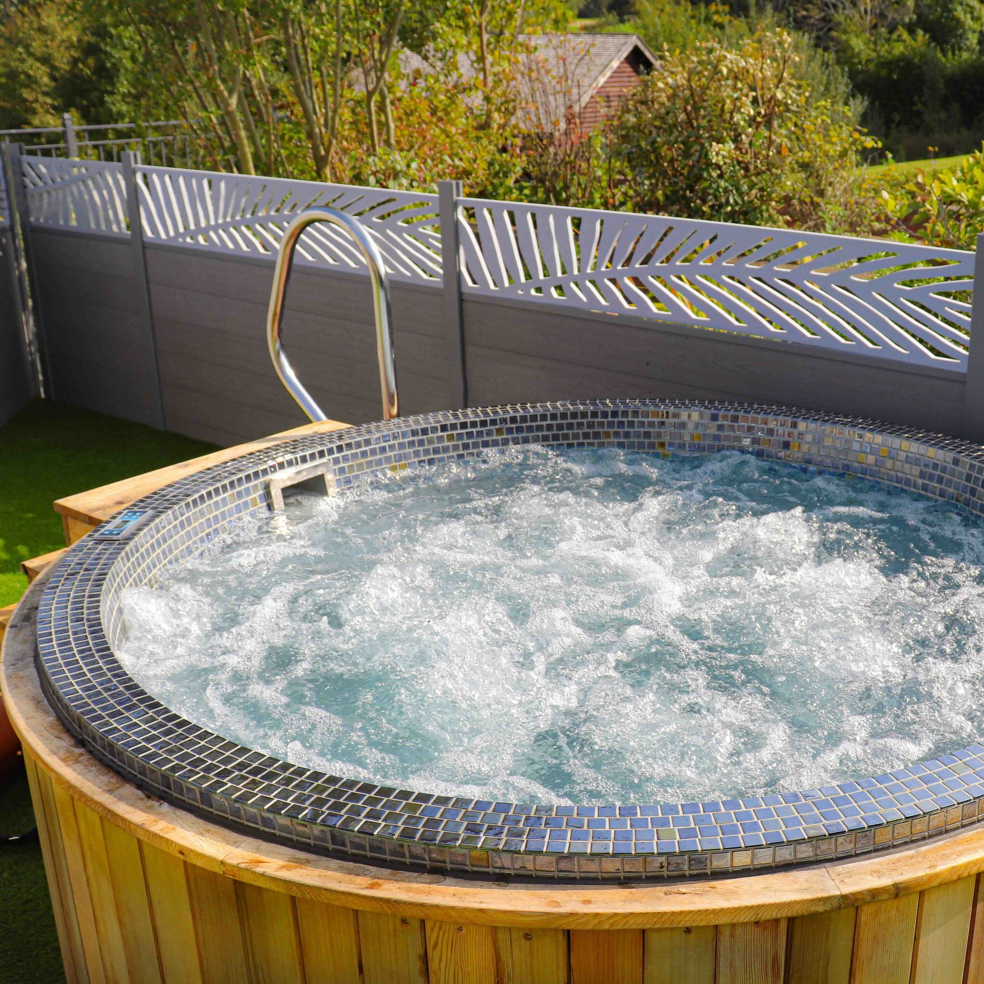 Spa Living Mosaic Round Vitality Spa Pool for 4 persons, featuring colorful mosaic tiles and built-in seating for relaxing spa experience.